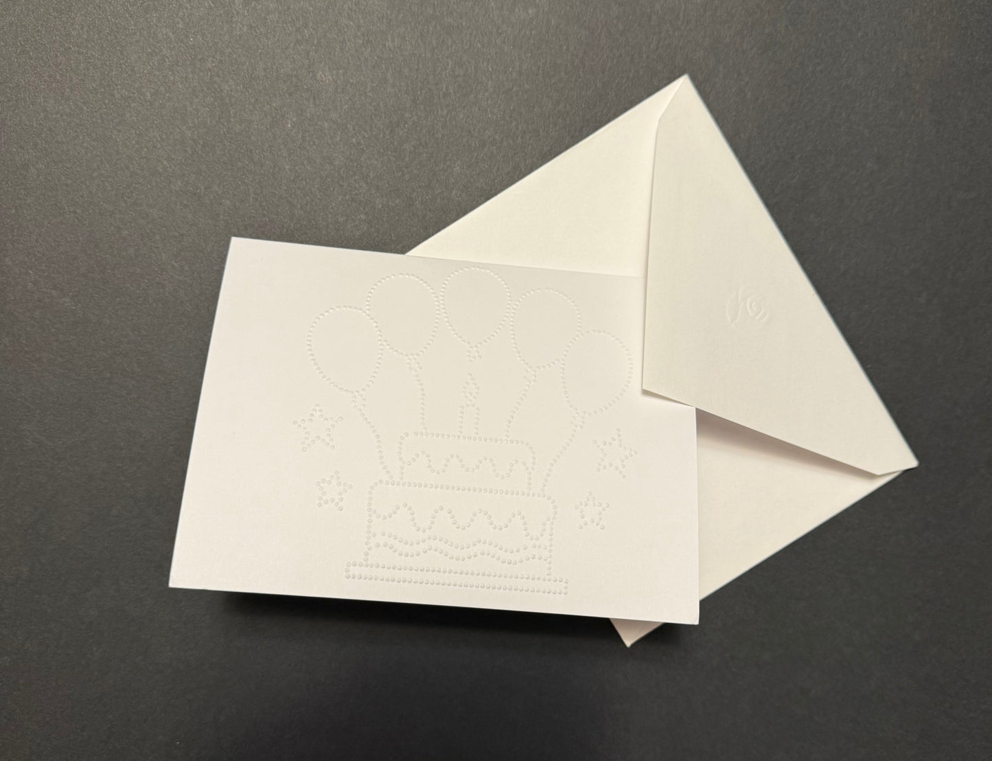 Braille birthday card with tactile cake and balloons