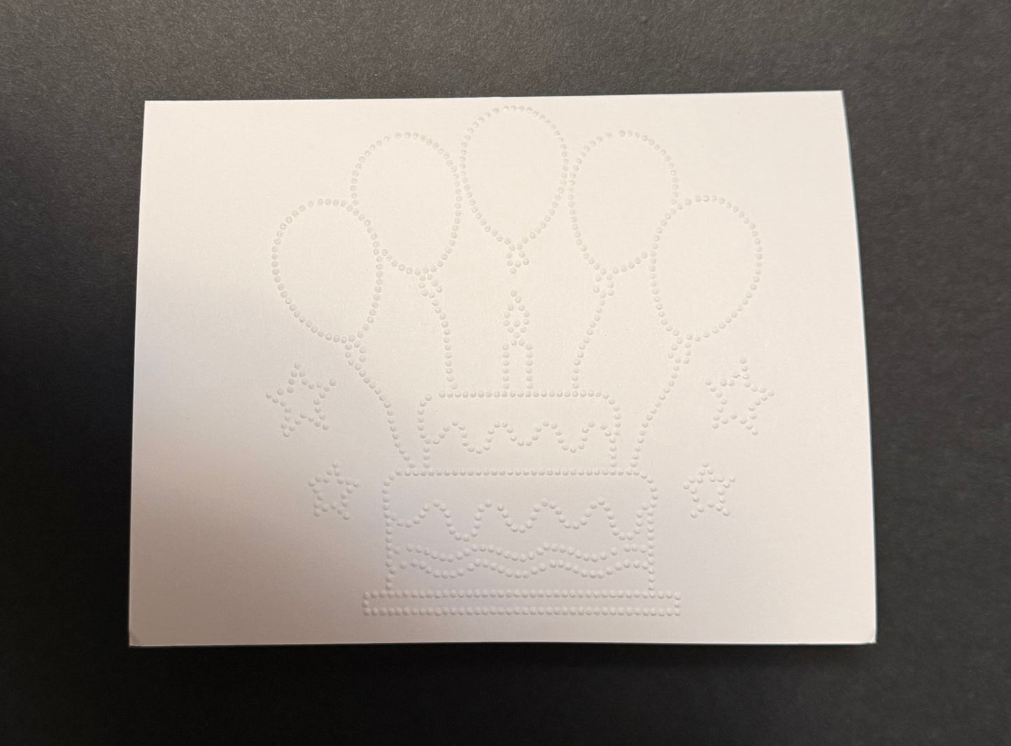 Braille birthday card with tactile cake and balloons