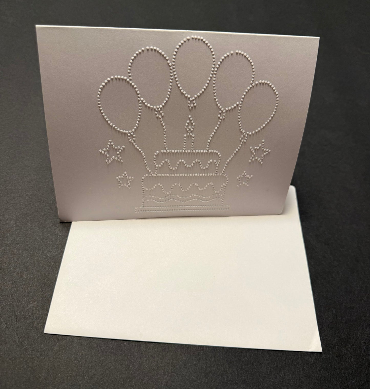 Braille birthday card with tactile cake and balloons